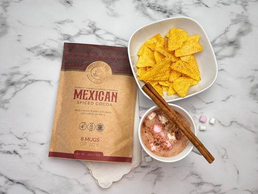 A serene mug of hot chocolate next to a busy espresso, representing calm over caffeine.