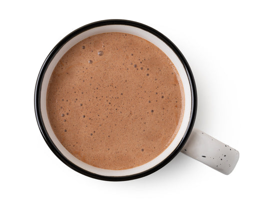 A mug of rich, frothed cocoa made without whipped cream or syrup, representing real adult hot chocolate